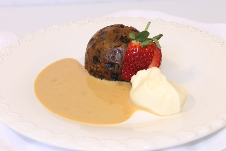 Delicious mini traditional pudding decorated on white plate