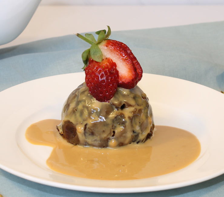 Delicious mini traditional pudding decorated on white plate