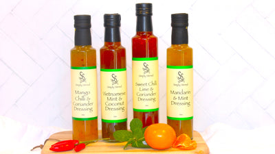 four bottles of Simply Stirred dressing