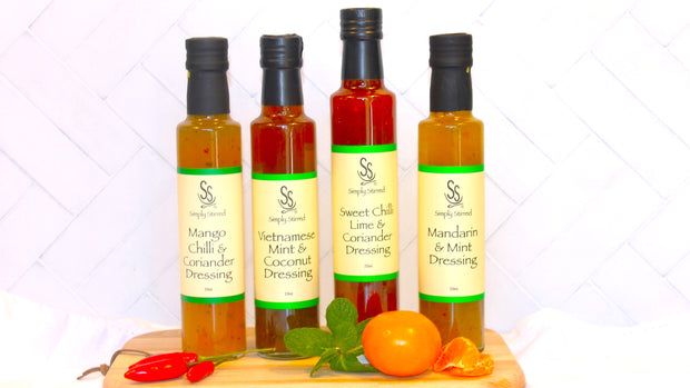 four bottles of Simply Stirred dressing