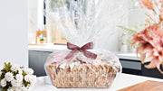 Three boxes of cookies, cake and sauce in gift basket